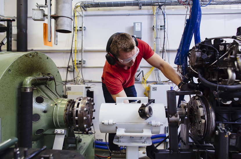 A student works on an engine in lab