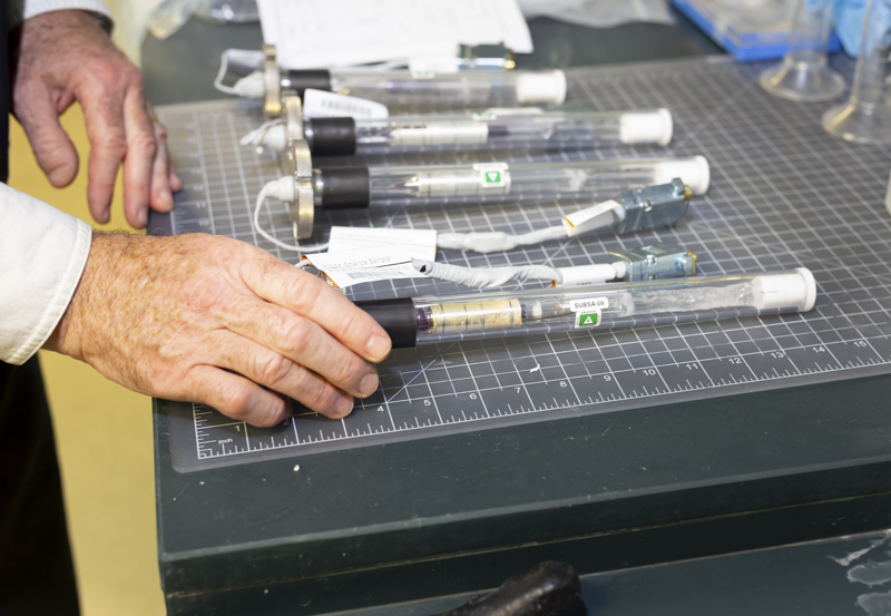 A professor handles crystals grown in space orbit