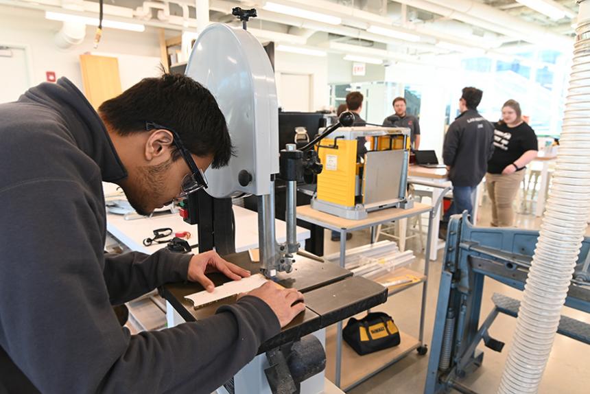 A student working on a machine inside the Idea Shop