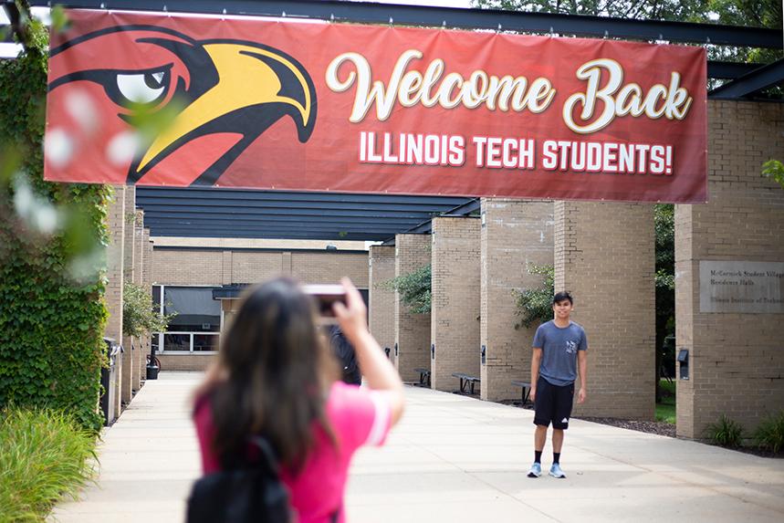 A family member taking a photo of an incoming student outside of MSV