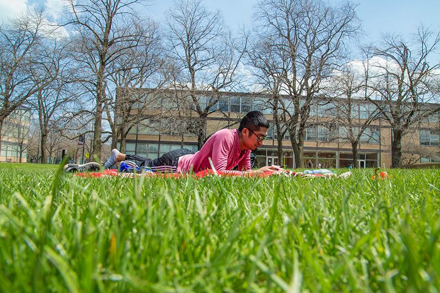 A student studying outside on Mies Campus