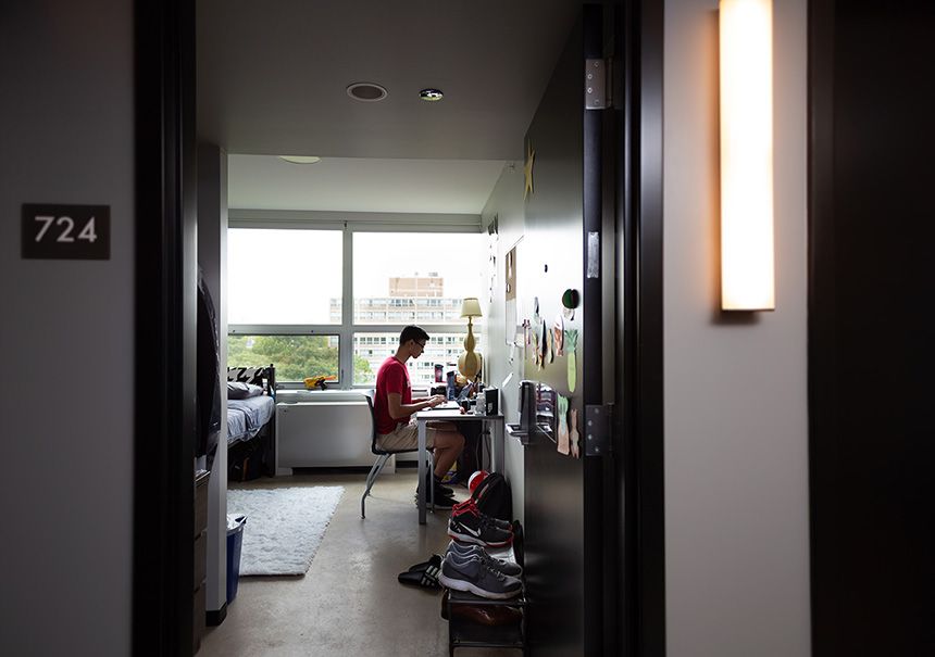 A student studies in their room in Kacek Hall