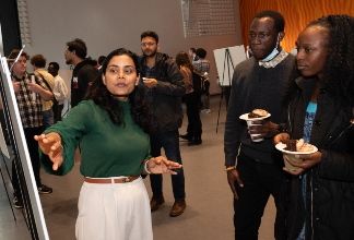 An applied mathematics students explains her research to guests at the 2024 Menger Awards and Lecture