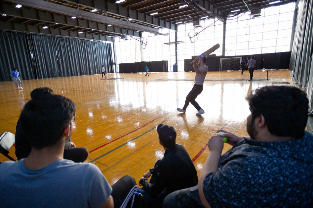 Illinois Tech students enjoy the final game of the cricket indoor league.