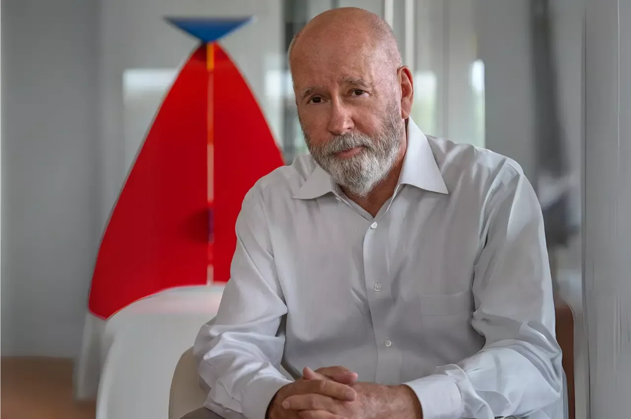 David Hovey Sr Honorary Doctor of Architecture awardee sitting in front of artwork