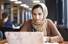 A Chicago-Kent Student studies in the Law Library