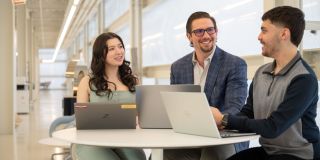 A group of IO Psychology students sit around a table