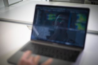 Illinois Tech computing alum Patrick Hamilton works on his laptop