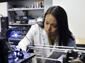 A student prepares a lymph node for laser analysis