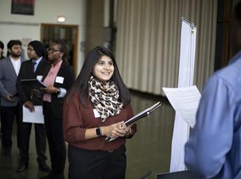 A student speaks to a potential employer at a career fair