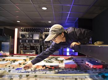 WISER - photo of person working on model of campus's smart grid