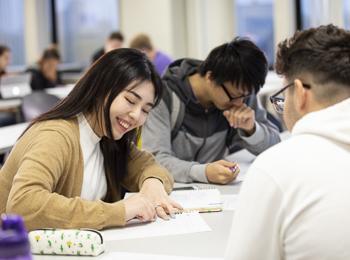 A student takes notes in a psychology class