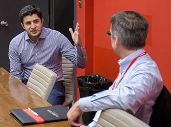 A student and faculty member talking to each other