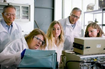 Photo of students and faculty at work in physics radiation lab