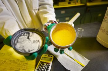 A researcher displays quantities of a compound