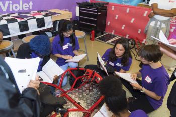 High schoolers work on a derby car