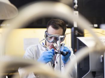 A illinois Tech student works to build a solar cell in a chemical engineering lab