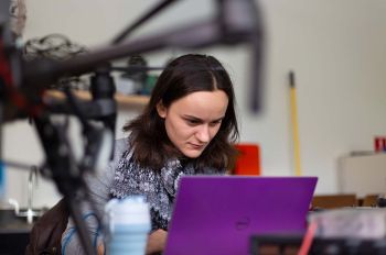 Student working with a drone and laptop