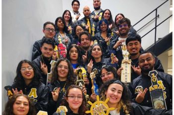 Illinois Tech chapter of Alpha Psi Lambda seated together on stairwell.