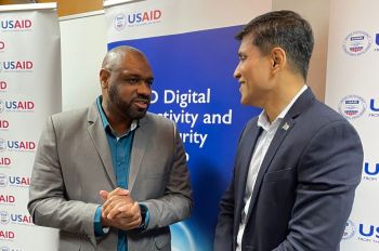 Maurice Dawson [left] talking to constituent in Fiji