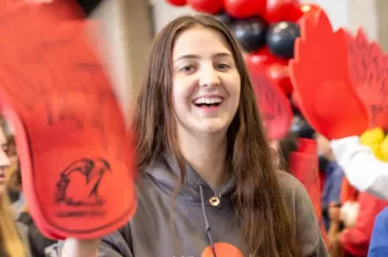 An Illinois Tech student smiles while walking on campus