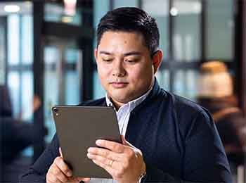 Stuart graduate student with tablet