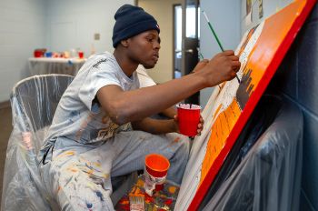 Dunbar Vocational Career Academy student Tamarion McClinton paints during a summer program offered by Illinois Tech’s Office of Community Affairs and Outreach Programs