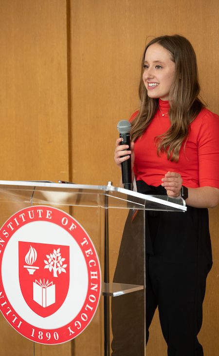 Photo of Ava Kelly speaking at podium