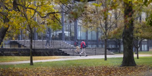 Students exit Crown Hall on a snowy fall day