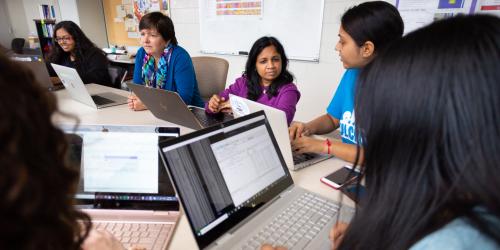 Photo of Computer Science professor working with students