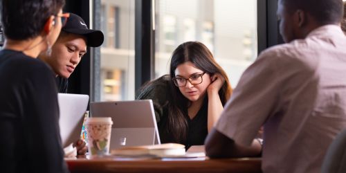 Photo of Stuart School of Business students working on computers together