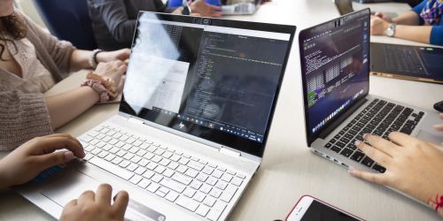 Two women work on code