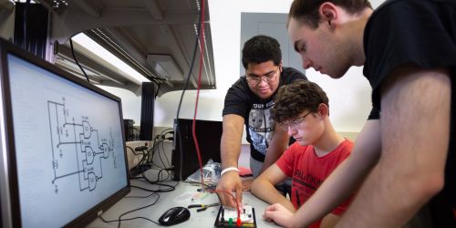 Photo of electrical engineering students at work in a lab