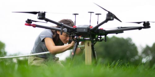 individual getting a drone ready to fly