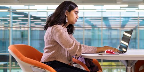 Female student in front of a laptop