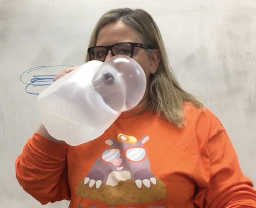 woman blowing in milk jug