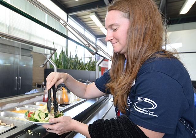 Current student getting food inside the Commons