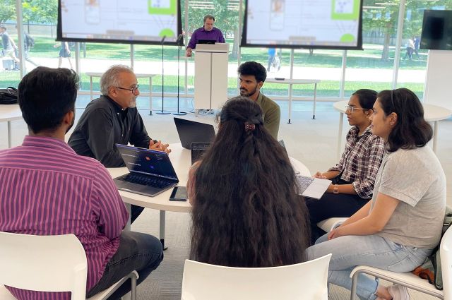 Leap of Faith founder Frank Nayemi-Rad, second from left, confers with interns at the Health Tech Talent Institute at Illinois Tech.