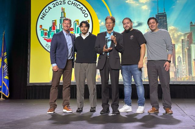 (From left to right) Image of Executive Director of Electri International Josh Bone, Aaron Jimenez, Adjunct Professor at Illinois Tech Dan Tomal, Christyn Reyes, Jose Alonzo standing on stage.