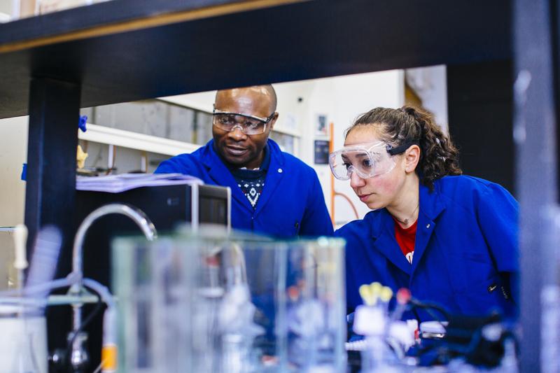 A professor and student work in a chemistry lab