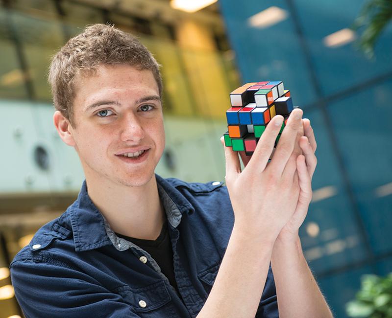 Alumni Dane Christianson holding the X-Cube