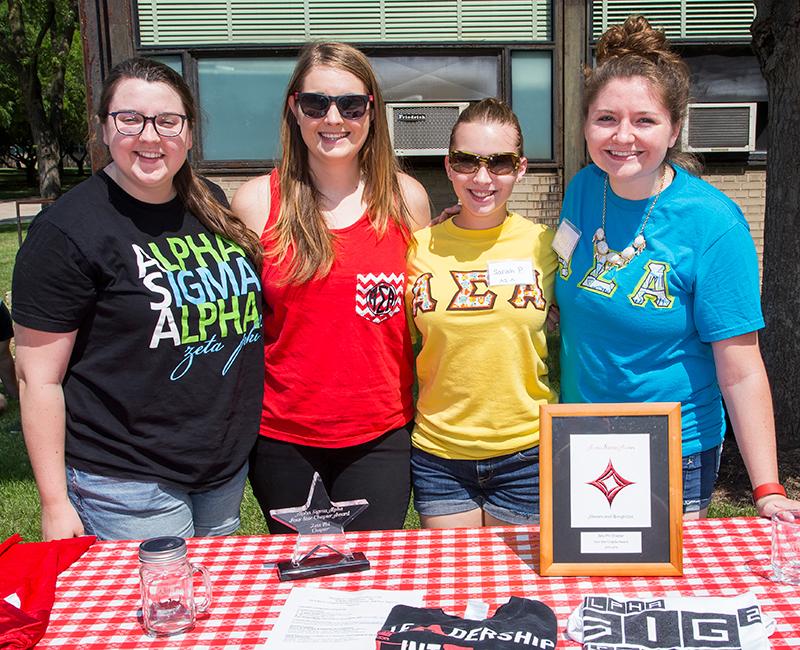 Female students from a greek organization standing together outside