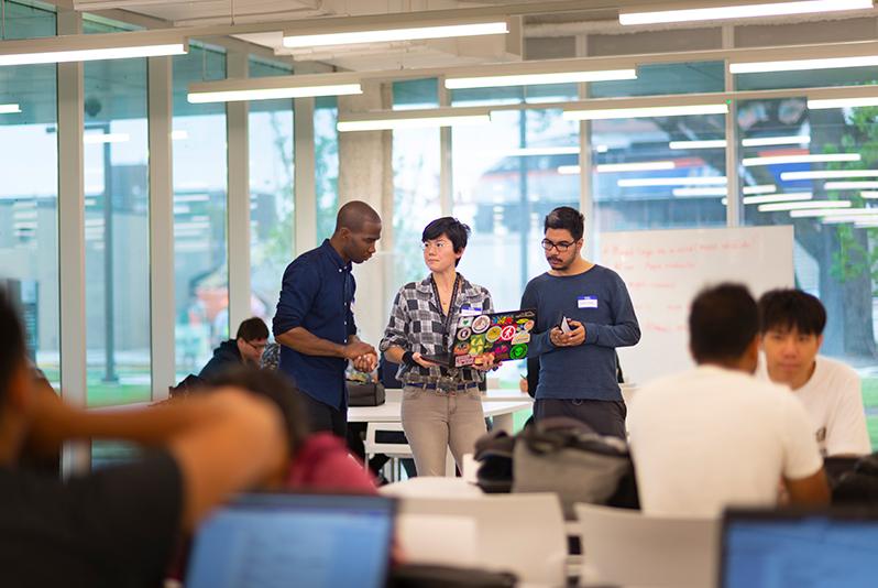 Faculty member talking to students during an IPRO class inside Kaplan Institute