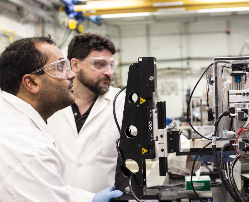 Joseph Orgel and a student examine tissue sample at Argonne National Laboratory