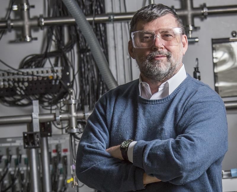 Irving stands in his lab