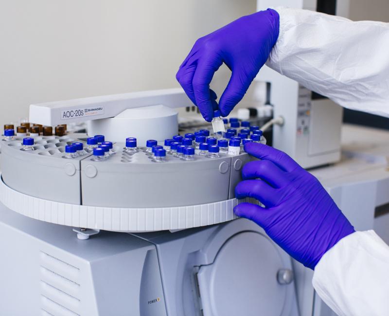 A researcher in a biology lap examines containers