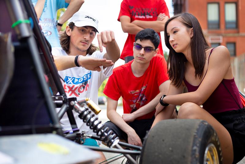 Students outside talking to the race club