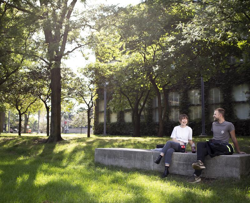 Students hang out on a pretty summer day