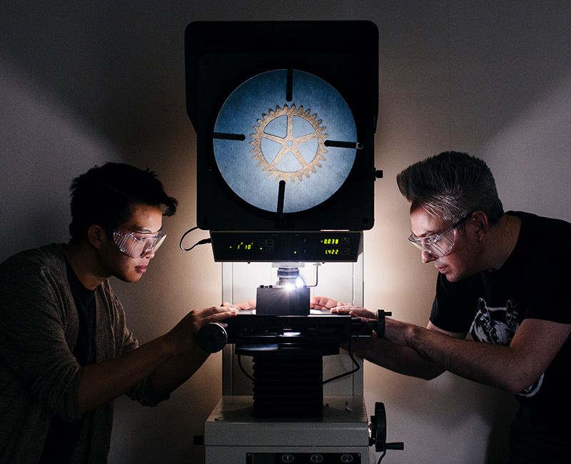 Machine Shop students working with Microscope