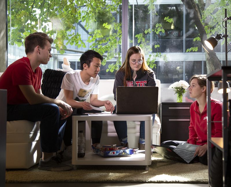 Students visit with an RA in Rowe village